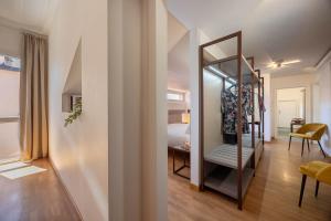 a hallway with a mirror and a room with a bed at Hotel Castello in LʼAquila +48 photos