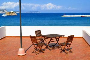 a table and chairs on a patio with the ocean at Maridea - Spiaggia Sant' Antonio in Ponza