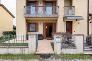 a house with a balcony on top of it at Appartamento Mary Monte Grappa in Borso del Grappa