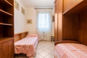 a bedroom with two beds and a window in it at Appartamento Mary Monte Grappa in Borso del Grappa