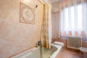 a bathroom with a tub and a toilet and a sink at Appartamento Mary Monte Grappa in Borso del Grappa +22 photos