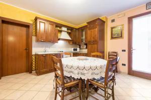 a kitchen with a table and chairs in a room at Appartamento Mary Monte Grappa in Borso del Grappa