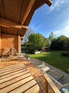 a wooden deck with benches on a house at Gemütliche Blockhütte in Wiennähe in Zöfing