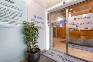 a door to a hotel vijaya restaurant with a plant at Hotel Vilagarcia in Vilagarcia de Arousa
