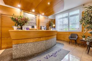 a waiting room with a counter and a chair at Hotel Vilagarcia in Vilagarcia de Arousa +63 photos