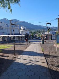 a sidewalk with street lights on the side of a road at Flor de Lis in Capilla del Monte +16 photos