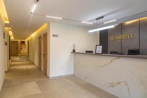 a lobby of a building with a reception counter at Seashell Suites in Abuja