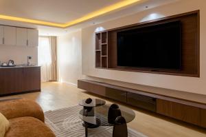 a living room with a large flat screen tv at Seashell Suites in Abuja