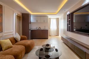 a living room with a couch and a table at Seashell Suites in Abuja