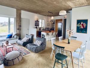 a living room with a table and a dining room at Galini House Private Villa in Andros in Órmos