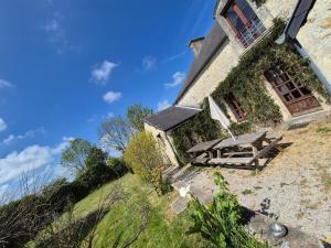 a house with a picnic table on the side of it at Le Longbeach 1 in Longueville +13 photos