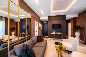 a living room with a couch and a tv at Premium Hotel, Novi Sad in Novi Sad