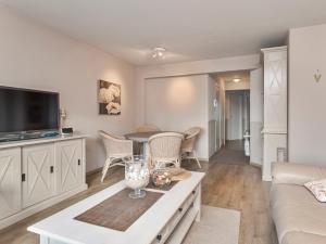 a living room with a couch and a table at Beaufort 0401 in Wenduine +9 photos
