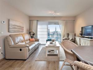 a living room with a couch and a table at Beaufort 0401 in Wenduine