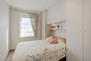 a bedroom with a bed and a window at Beaufort 0401 in Wenduine