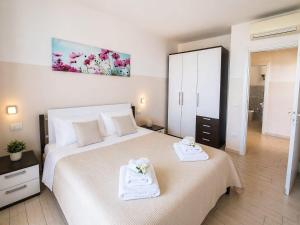 a bedroom with a large bed with towels on it at Miramare Castello in Castelsardo +52 photos