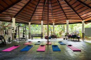 a yoga class in a pavilion with yoga mats at Nawa Wellness in Calatagan