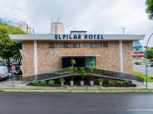 a hotel building with a sign on top of it at Hotel El Pilar by Bsb Inn in Brasília