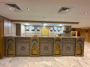 an altar in a building with clocks on the wall at Hotel Almas Meknes in Meknès