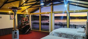 a bedroom with a christmas tree and a large window at Titicaca Uros Atardecer in Puno