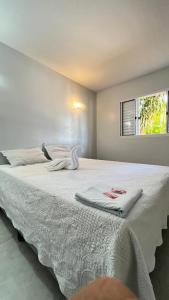 a bedroom with a large white bed with a window at Cardoso Palace Hotel Rio Verde in Rio Verde +45 photos