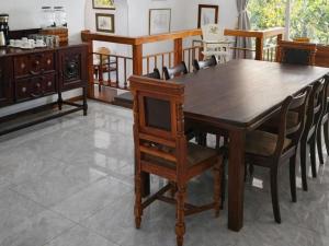 a dining room with a wooden table and chairs at Bushwillows B&B in Rustenburg