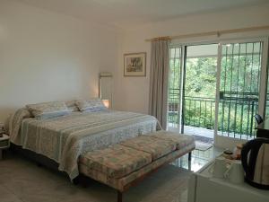 a bedroom with a bed and a large window at Bushwillows B&B in Rustenburg +37 photos