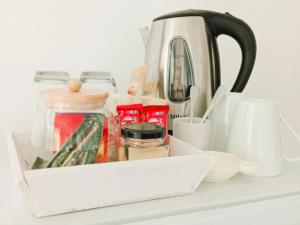 a tea pot and other kitchen utensils on a shelf at Bushwillows B&B in Rustenburg
