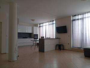 a large room with a kitchen and a living room at Midia Resort Aheloy in Aheloy