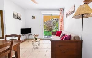 a living room with a couch and a table at Élégant T3 avec terrasse & piscine et parking in Prayssac