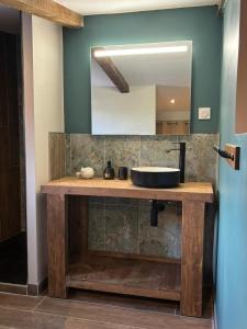 a bathroom with a sink and a mirror at Hôtel Aghjola in Pioggiola +34 photos