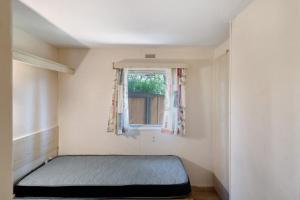 a bedroom with a bed and a window at Mobilehome chez dede in Porto-Vecchio