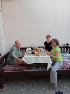 a group of people sitting around a table at Navruz Hostel in Samarkand