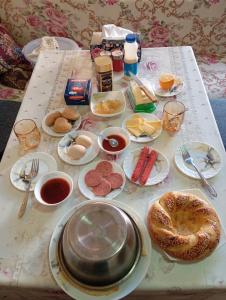 a table with plates of food on top of it at Navruz Hostel in Samarkand +7 photos
