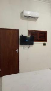 a room with a bed and a door and a air conditioner at Pousada Só Alegria in Fortaleza +44 photos