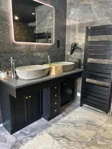 a bathroom with two sinks and a large mirror at Royal SPA Saarbrucken in Stiring-Wendel +19 photos