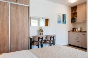a small kitchen with a table and chairs in a room at Apartmani IVA in Neum +31 photos