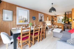 a dining room and living room with a table and chairs at Chalet le 22 Agniéres in Le Dévoluy +9 photos