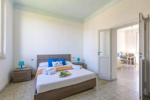 a bedroom with a large bed with blue pillows at Italian Experience-Casale Oleandro Marino in Porto Recanati