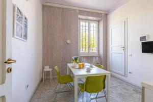 a dining room with a table and green chairs at Italian Experience-Casale Oleandro Marino in Porto Recanati +60 photos
