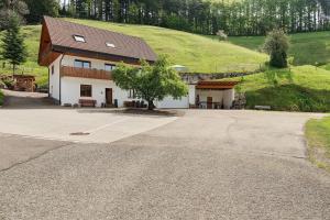 a house with a tree on the side of a road at Holderstanzenhof in Bad Griesbach