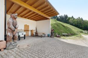 a statue of a bear standing next to a building at Holderstanzenhof in Bad Griesbach +77 photos