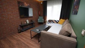 a living room with a couch and a brick wall at CONCEPT HoUSE in Ankara