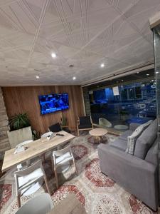 a living room with a couch and a table at Apart Sorrento in Santa Teresita