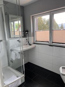 a bathroom with a shower and a sink at Parkhotel Krone Maleck in Emmendingen