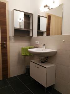 a bathroom with a sink and a mirror at Ferienwohnung Mair in Umhausen