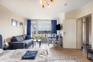 a room with a bed and a couch and a table at Panorama Suite Quickborn in Quickborn