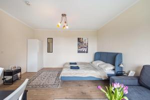 a living room with a bed and a couch at Panorama Suite Quickborn in Quickborn