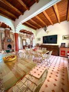 a large living room with a table and chairs at Riad Titima Essaouira in Essaouira