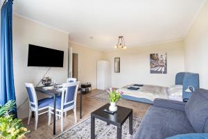 a living room with a couch and a table at Panorama Suite Quickborn in Quickborn